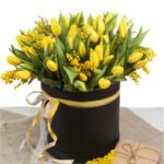 Bright spring bouquet of tulips and mimosa flowers. Mother's Day or Easter theme.